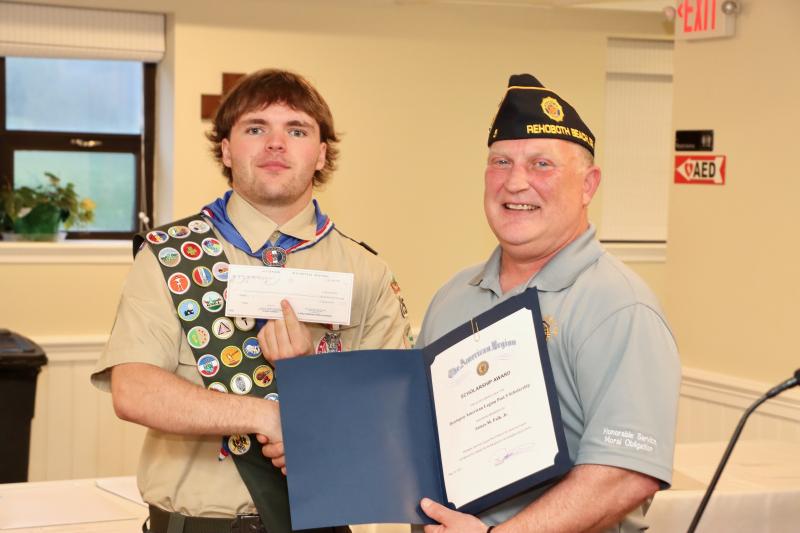 James Falk Jr. receives a $4,000 scholarship from American Legion Post 5 Adjutant Ron Webster. Falk will be attending the University of Delaware in the fall.